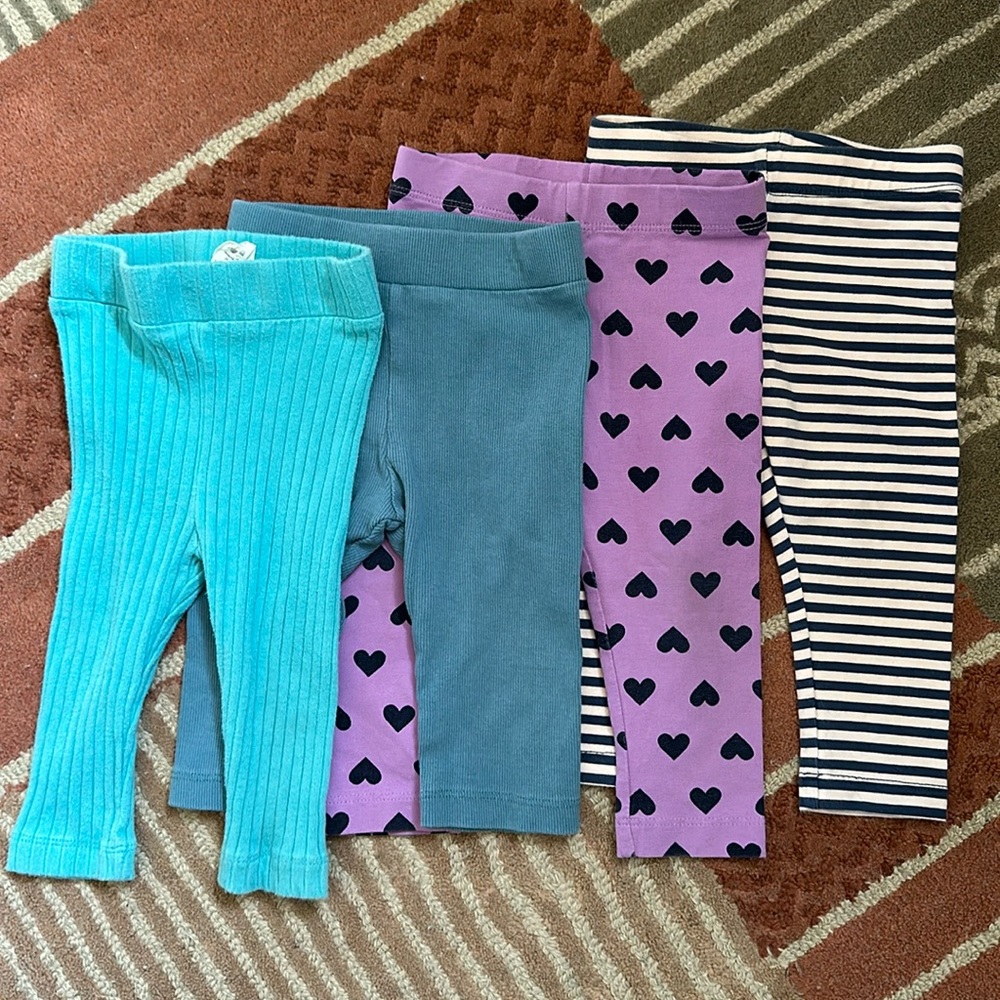 Four pairs of leggings, size 6-12 months. Brands Primary and Kate Quinn.
